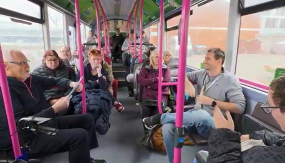 Smiling people seated on a bus