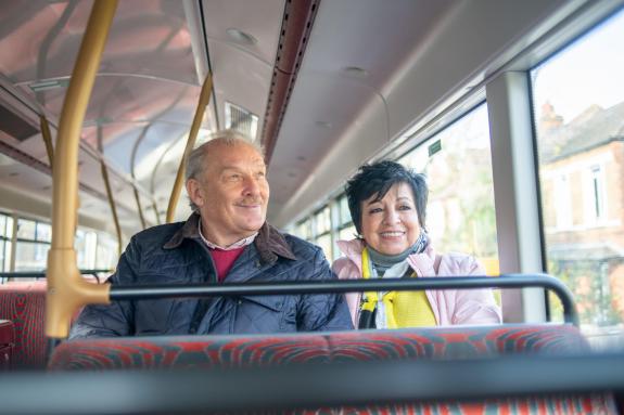 2 people sat on the top storey of a bus