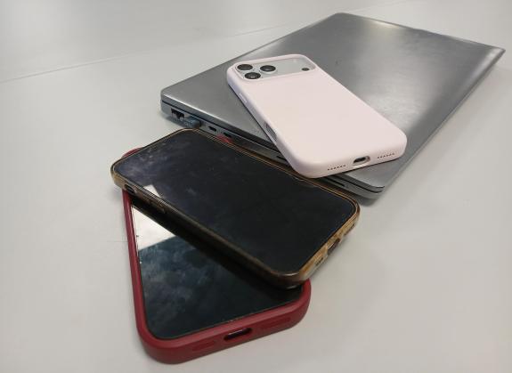 This is an image of a laptop and mobile phones